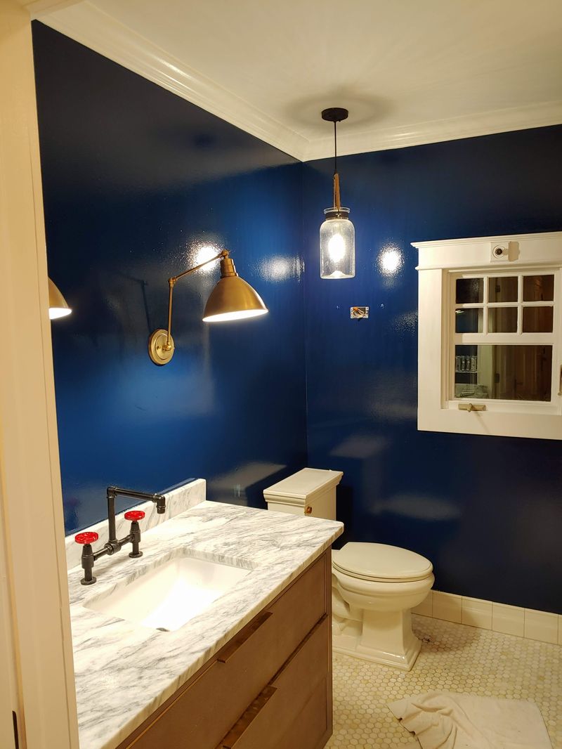 Navy bathroom with marble vanity during construction