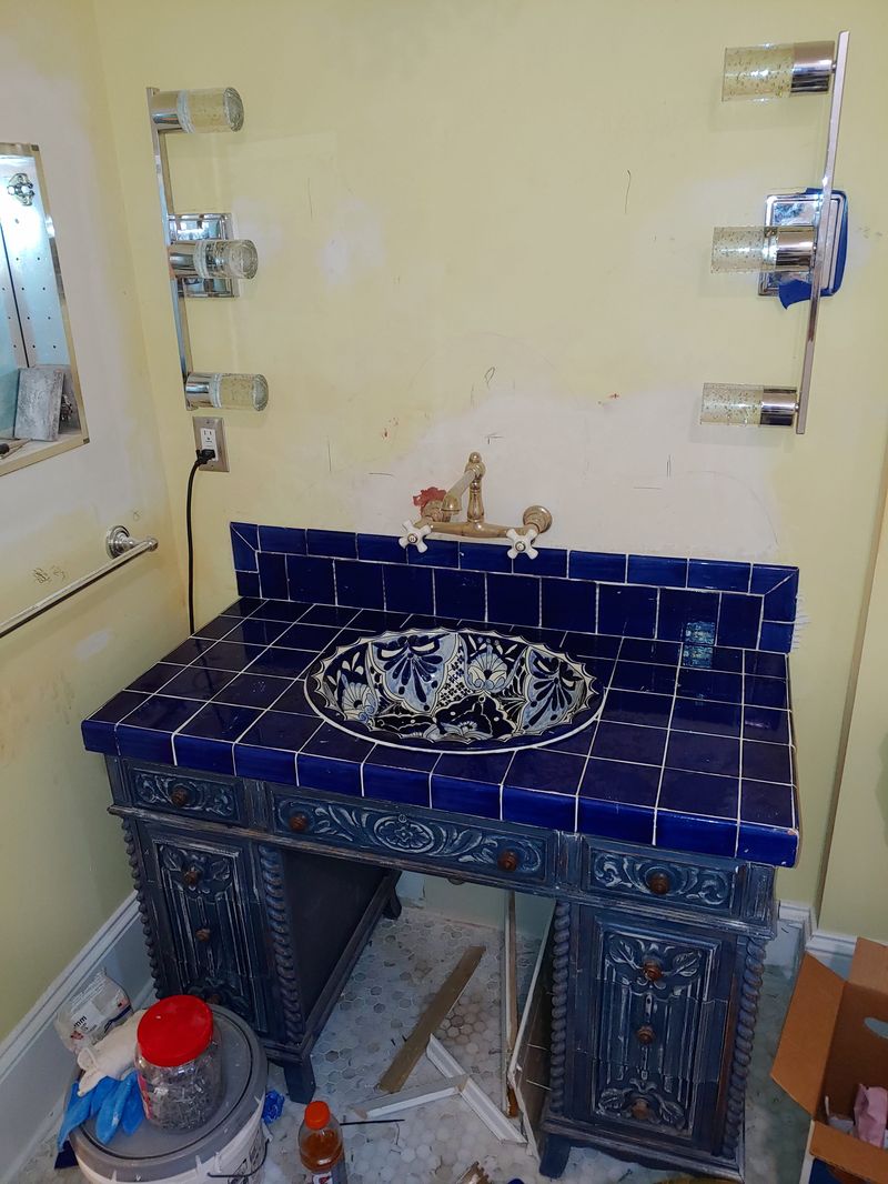 Bathroom vanity with blue tile top during construction