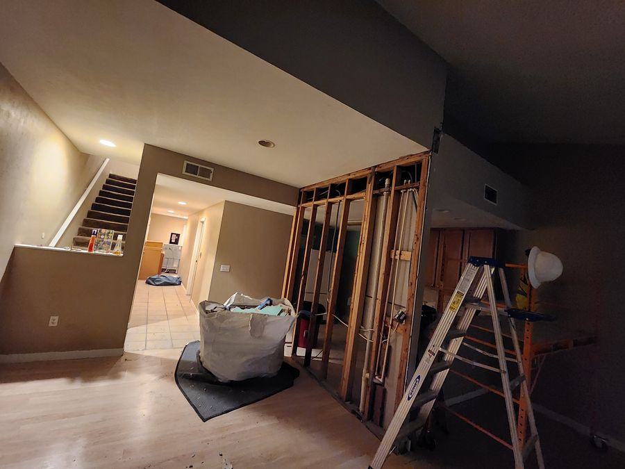 Framed wall opening with stairs visible beyond